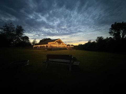 Our place at dusk, with string lights glowing on the porch